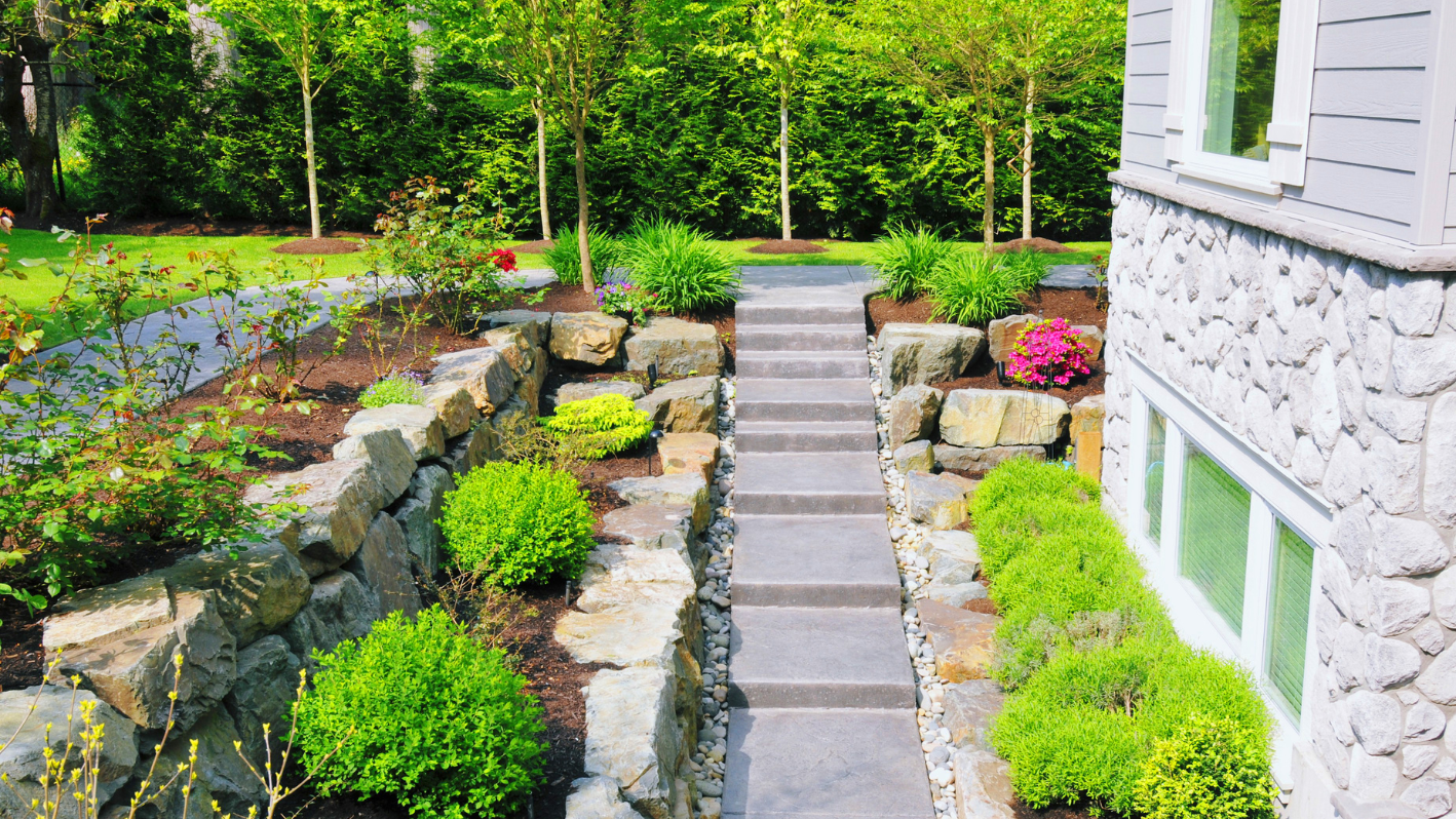 A stone path leading to a house in the woods