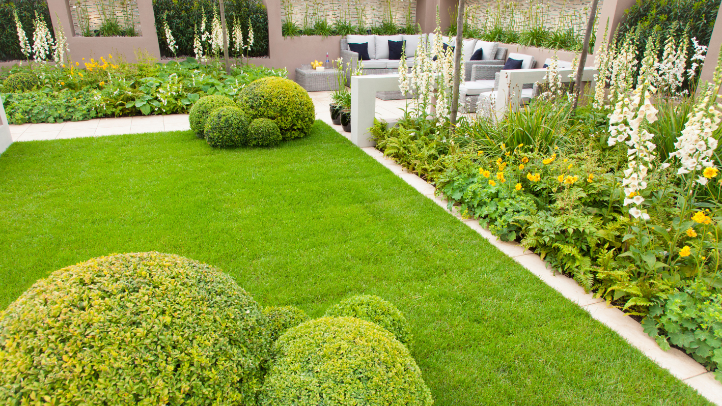 A very nice looking garden with lots of green grass