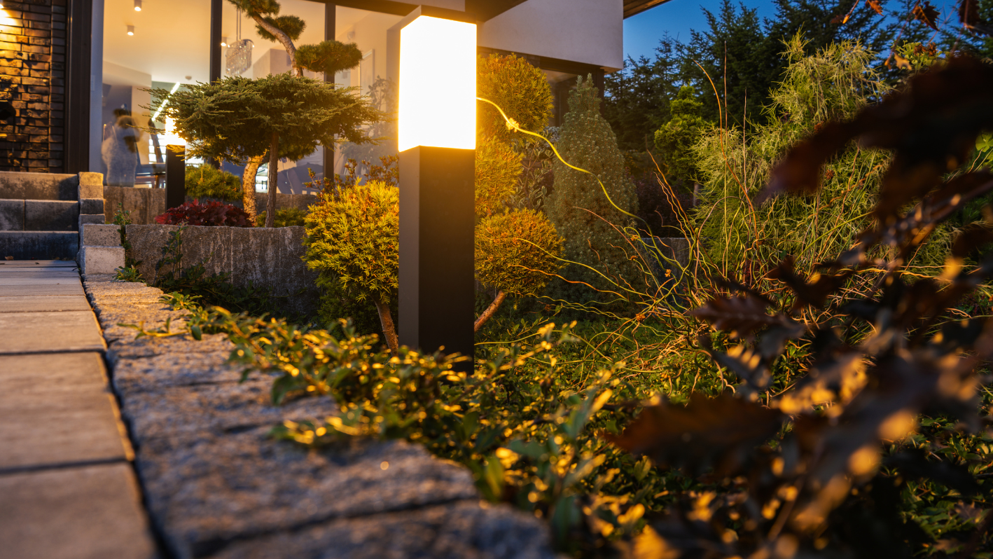 A street light sitting in the middle of a garden